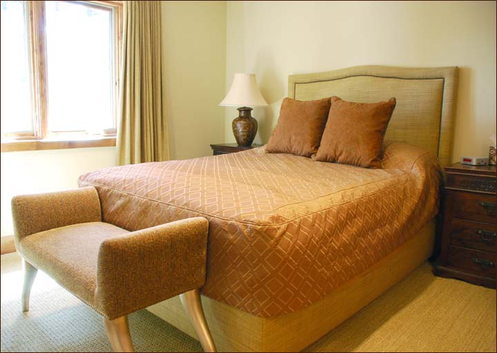 Another queen master bedroom features a private en-suite bath and cozy fine linens also situated on the lower level away from the excitement of the great room.