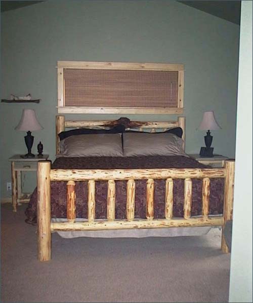 King sized master bedroom richly decorated with Ralph Lauren accents .