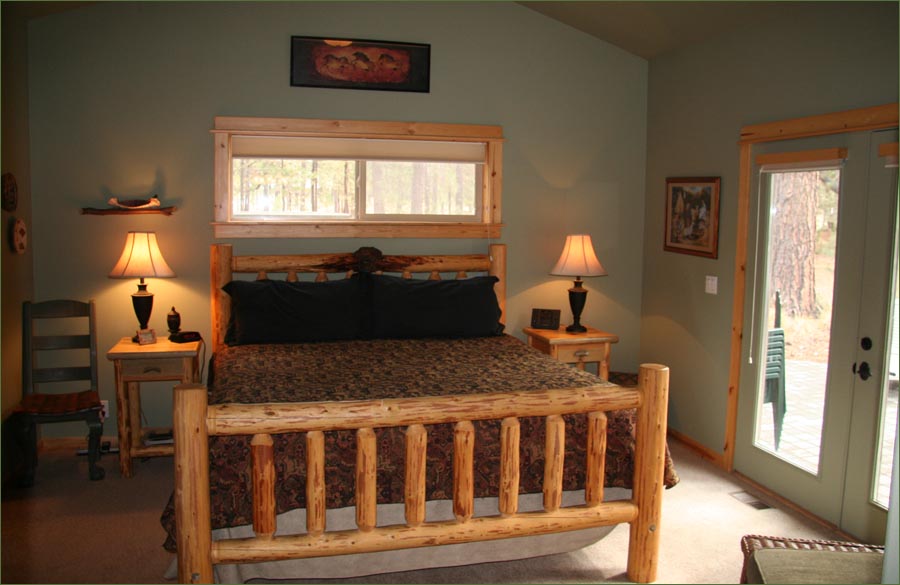 King sized master bedroom richly decorated with Ralph Lauren accents .