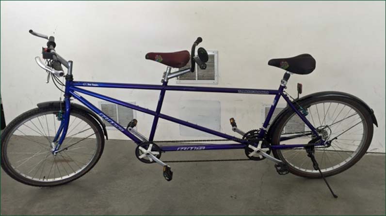 New tandem adult bike with helmets.