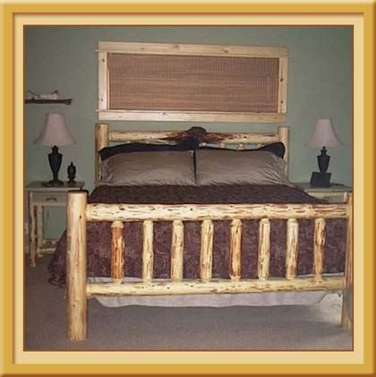 King sized master bedroom richly decorated with Ralph Lauren accents .