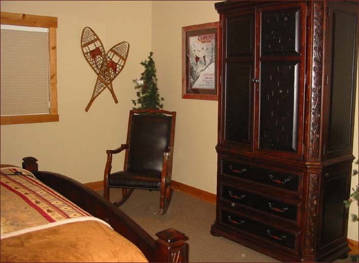 Guestroom with queen bed, entertainment center and private bath.