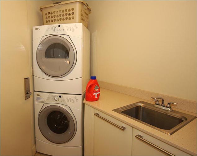 Laundry room with, high performance front loading washer and dryer and generous stainless steel laundry sink sink.