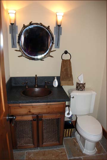 Ideal for guests this main level guest bathroom is located at the foot of the stairs for convenience to the great room and loft above.