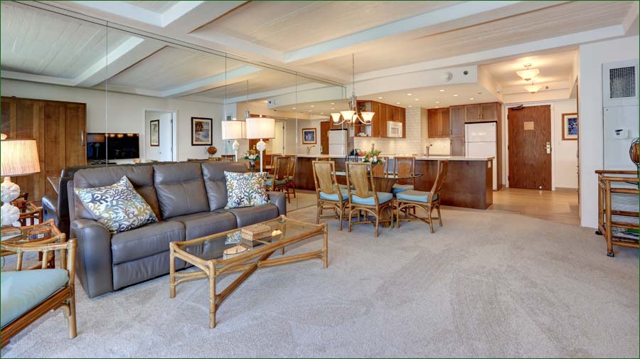 Spacious living room includes a comfortable sofa, private ocean view balcony, murphy bed and entertainment center with cable TV/DVD/VCR. 