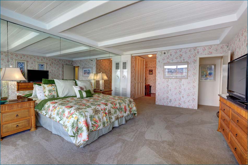 Master bedroom includes a king bed, TV and private lanai with forever views of the beach, pool and ocean. 