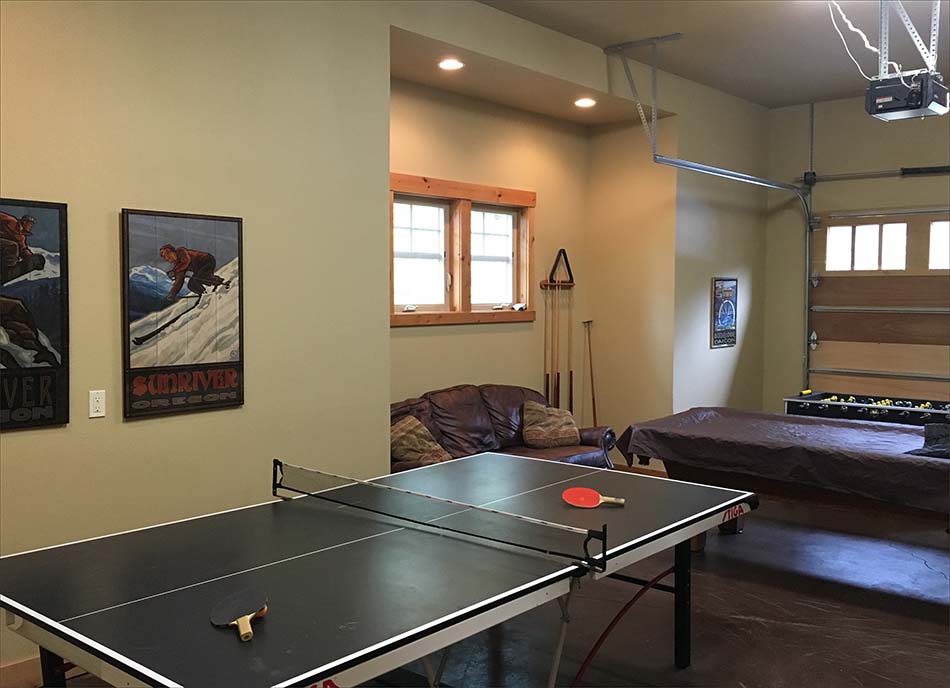 Garage recreation room with fooseball, ping pong and pool tables.