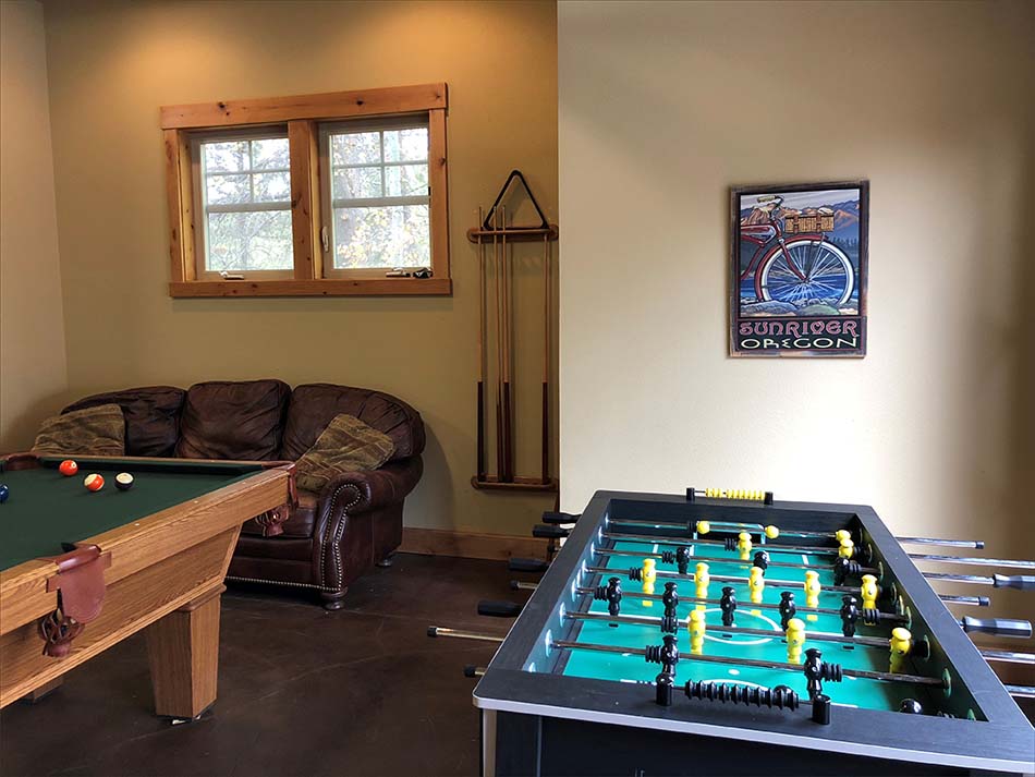 Garage recreation room with fooseball, ping pong and pool tables.