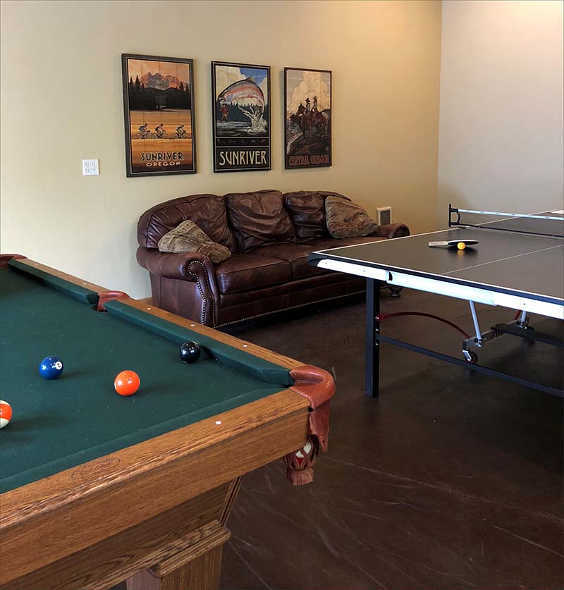 Garage recreation room with fooseball, ping pong and pool tables.