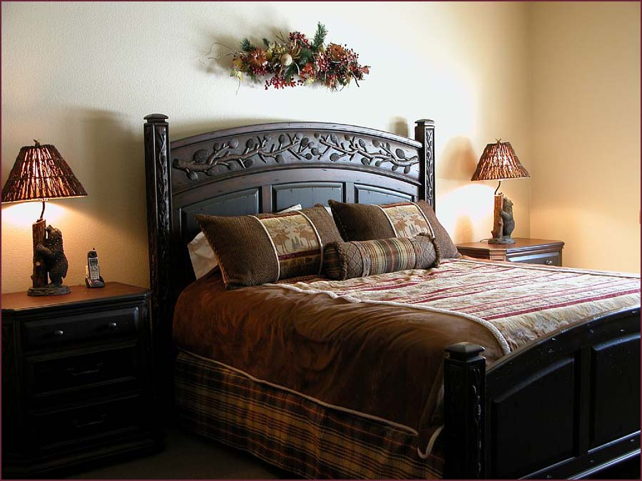 Guestroom with queen bed, entertainment center and private bath.