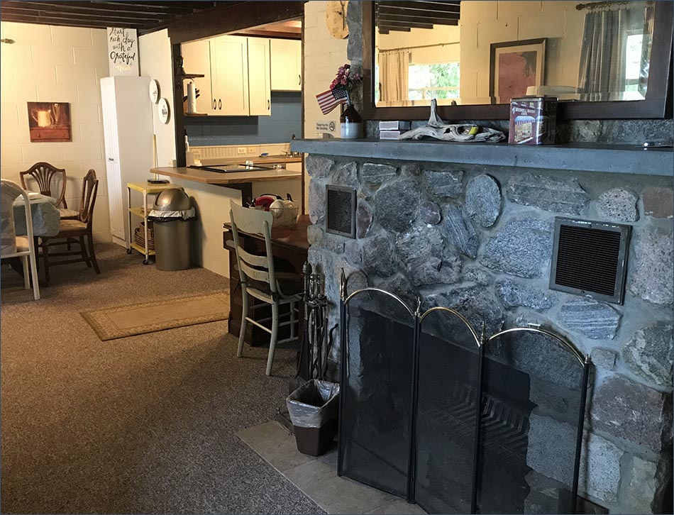 Torch Lake vacation rental with rock fireplace and new kitchen