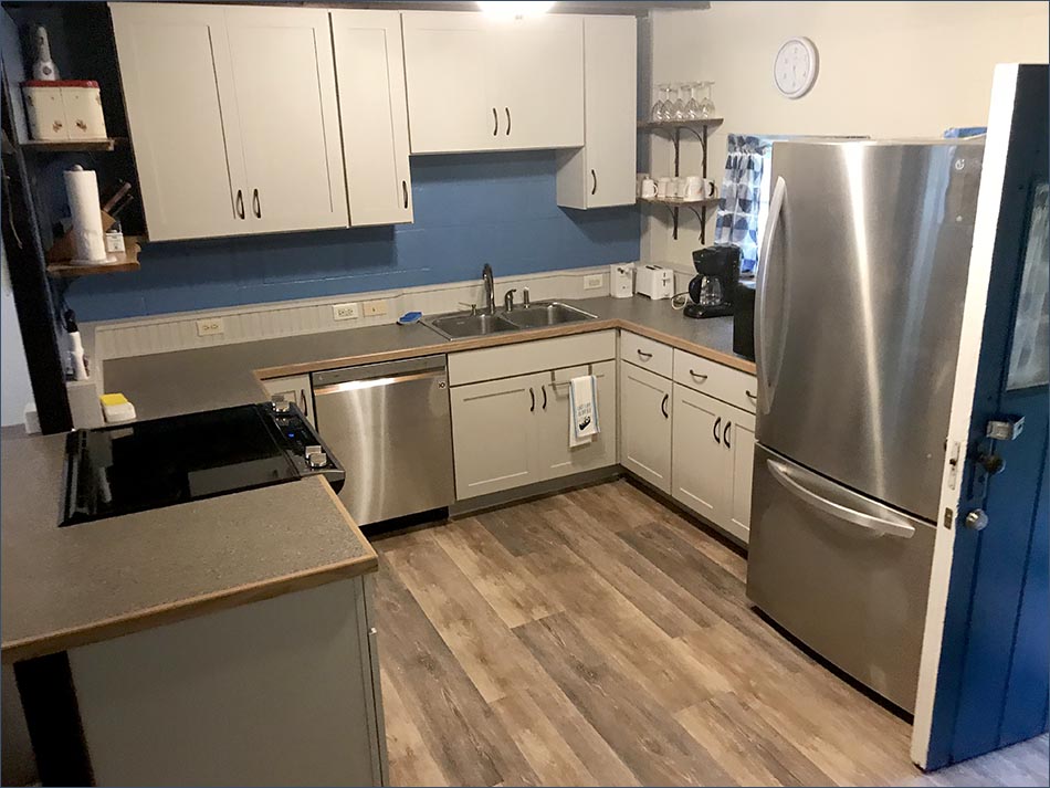 An newly updated, fully equipped kitchen with stove, microwave, pots, pans and serving ware for a family of 10.